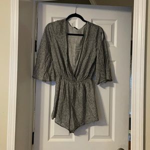 Dainty Hooligan Romper. Never worn with tags. Sleeves open to show shoulder